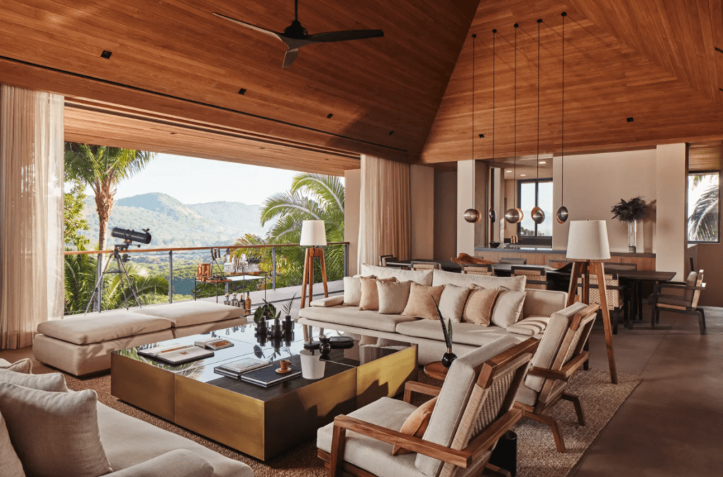 living room with vaulted ceilings and jungle views