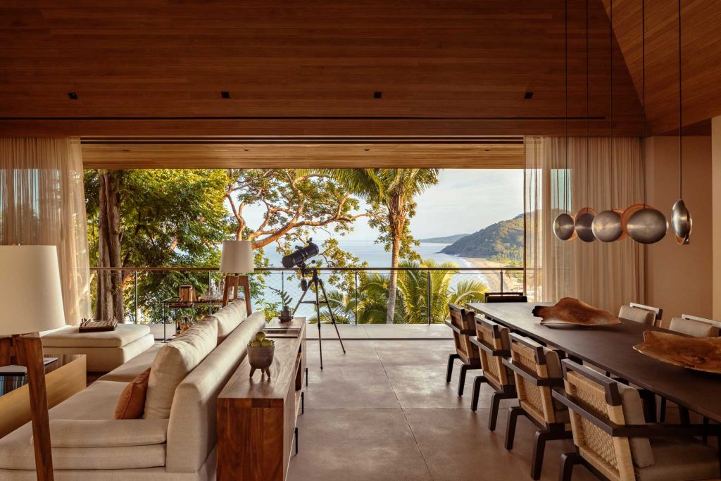 open-plan living room looking out through open wall of windows