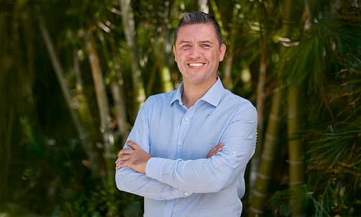 general manager of on&only mandarina smiles in front of lush jungle background